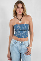 Woman wearing TIC TOC TA29069-BECKEE BECKEE embroidered western corset top featuring a strapless straight neckline, boned panel construction, dual lined PU vegan leather body, and rope lace-up detail at the center back, styled with high-waisted denim for a bold rodeo-ready western going-out look.