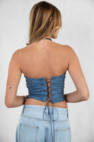 Woman wearing TIC TOC TA29069-BECKEE BECKEE embroidered western corset top featuring a strapless straight neckline, boned panel construction, dual lined PU vegan leather body, and rope lace-up detail at the center back, styled with high-waisted denim for a bold rodeo-ready western going-out look.