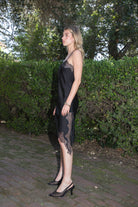 Woman wearing TIC TOC DA31971 LINORA satin lace contrast V-neck mini dress featuring a soft satin body, scalloped lace trim at the neckline, thin adjustable straps, asymmetrical lace-trim hem, and side slit detail for a sleek feminine night-out look.