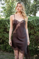 Woman wearing TIC TOC DA31971 LINORA satin lace contrast V-neck mini dress featuring a soft satin body, scalloped lace trim at the neckline, thin adjustable straps, asymmetrical lace-trim hem, and side slit detail for a sleek feminine night-out look.