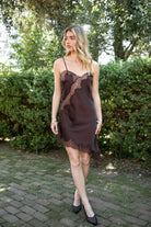 Woman wearing TIC TOC DA31971 LINORA satin lace contrast V-neck mini dress featuring a soft satin body, scalloped lace trim at the neckline, thin adjustable straps, asymmetrical lace-trim hem, and side slit detail for a sleek feminine night-out look.