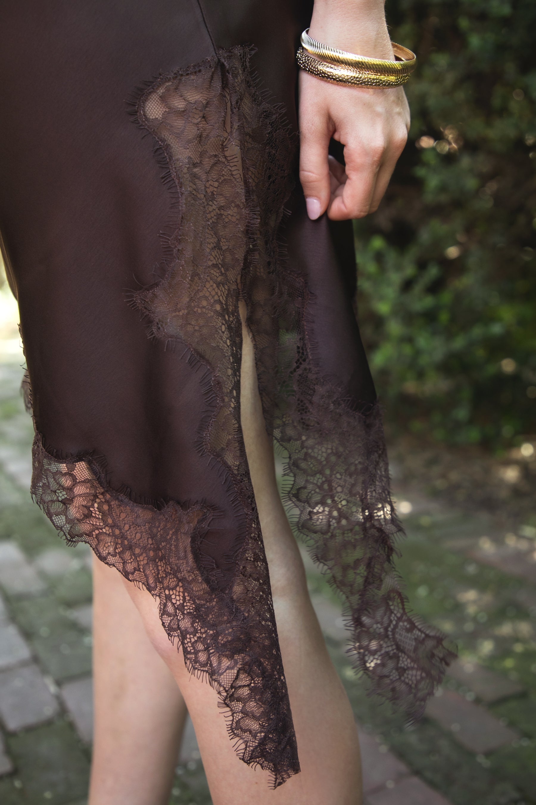 Woman wearing TIC TOC DA31971 LINORA satin lace contrast V-neck mini dress featuring a soft satin body, scalloped lace trim at the neckline, thin adjustable straps, asymmetrical lace-trim hem, and side slit detail for a sleek feminine night-out look.