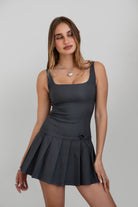 TIC TOC DC30797 ADRINA Charcoal Drop Waist Mini Dress with pleated skirt and bow detail.