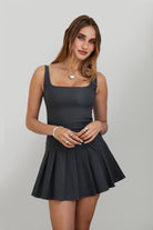 DC30797-ADRINA Drop Waist Mini Dress is flirty, fitted, and made to stand out. Featuring a square neckline with supportive fixed straps, this dress hugs the body through the waist and flares into a pleated mini skirt with a playful bow detail. Finished with a hidden back zipper and crafted from stretch millennium fabric for a smooth, sculpted fit—perfect for nights out, date plans, or any moment worth dressing up.

Stretch Millennium Fabric