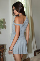 Women wearing TIC TOC AZALEA One Shoulder Mini Dress in heather grey with twisted strap, ruching, studded detail, and flirty hemline in doors. 