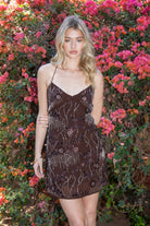 Woman wearing TIC TOC DL31853 VEDA chiffon sequin beaded lace-up mini dress featuring intricate floral bead and sequin embroidery, a flattering V-neckline with slim halter strap, open back design with adjustable lace-up tie, and a body-skimming mini silhouette for a radiant festival and summer night-out look.