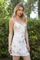 Woman wearing TIC TOC DL31853 VEDA chiffon sequin beaded lace-up mini dress featuring intricate floral bead and sequin embroidery, a flattering V-neckline with slim halter strap, open back design with adjustable lace-up tie, and a body-skimming mini silhouette for a radiant festival and summer night-out look.