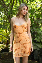 Woman wearing TIC TOC DL31853 VEDA chiffon sequin beaded lace-up mini dress featuring intricate floral bead and sequin embroidery, a flattering V-neckline with slim halter strap, open back design with adjustable lace-up tie, and a body-skimming mini silhouette for a radiant festival and summer night-out look.