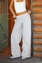 Woman wearing gray TIC TOC CASSE Fleece Sweatpants with built-in gingham boxer, front view with a matching rib tank top in a cabin. 