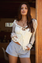 PC31149 BUNBUN &nbsp;Gingham Elasticated Shorts are the perfect blend of cozy and cute. Designed in a classic boxer fit with a low-rise stretch waistband and faux button detail, these lightweight gingham shorts are ideal for lounging or styling up for a casual day out. Pair with a baby tee, oversized sweatshirt, or matching gingham cami for that effortless "off-duty" look that's trending this season.