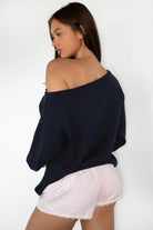 Woman wearing TIC TOC PC31878-BLUBELL BLUBELL low rise lace trim shorts in a soft blue vertical stripe pattern, featuring a stretch low rise waistband, faux button front detail, delicate lace hem and side lace accents, styled with a simple camisole for a cozy lounge and sleepwear look.