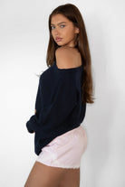 Woman wearing TIC TOC PC31878-BLUBELL BLUBELL low rise lace trim shorts in a soft blue vertical stripe pattern, featuring a stretch low rise waistband, faux button front detail, delicate lace hem and side lace accents, styled with a simple camisole for a cozy lounge and sleepwear look.