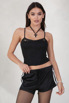 GINAH Solid Low-Rise Sport Shorts 
Elasticated Waistband With Connected Lace Tie 
White Side Straps 
Black Double Lined Nylon Fabric 