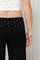 Woman wearing TIC TOC PH31998 SORA rayon fold over waist wide capri leggings featuring a soft lightweight stretch fabric, fold-over waistband with polka dot contrast detail, easy pull-on fit, and relaxed wide leg capri silhouette for a clean lounge and active-inspired everyday look.