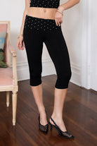 Woman wearing TIC TOC PH31999 SORA rayon fold over waist polka dot capri leggings pants featuring a smooth stretch fabric, contrast polka dot fold-over waistband, mid-rise fit, slim body-hugging silhouette, and clean capri length for a sporty feminine everyday look.