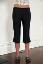 Woman wearing TIC TOC PH32127 COLETTE slit cropped dress pants featuring a sleek tailored capri silhouette, mid rise waistband with belt loops and adjustable tie detail, subtle side slit hem, and smooth stretch dobby fabric for a polished minimal day-to-night look.