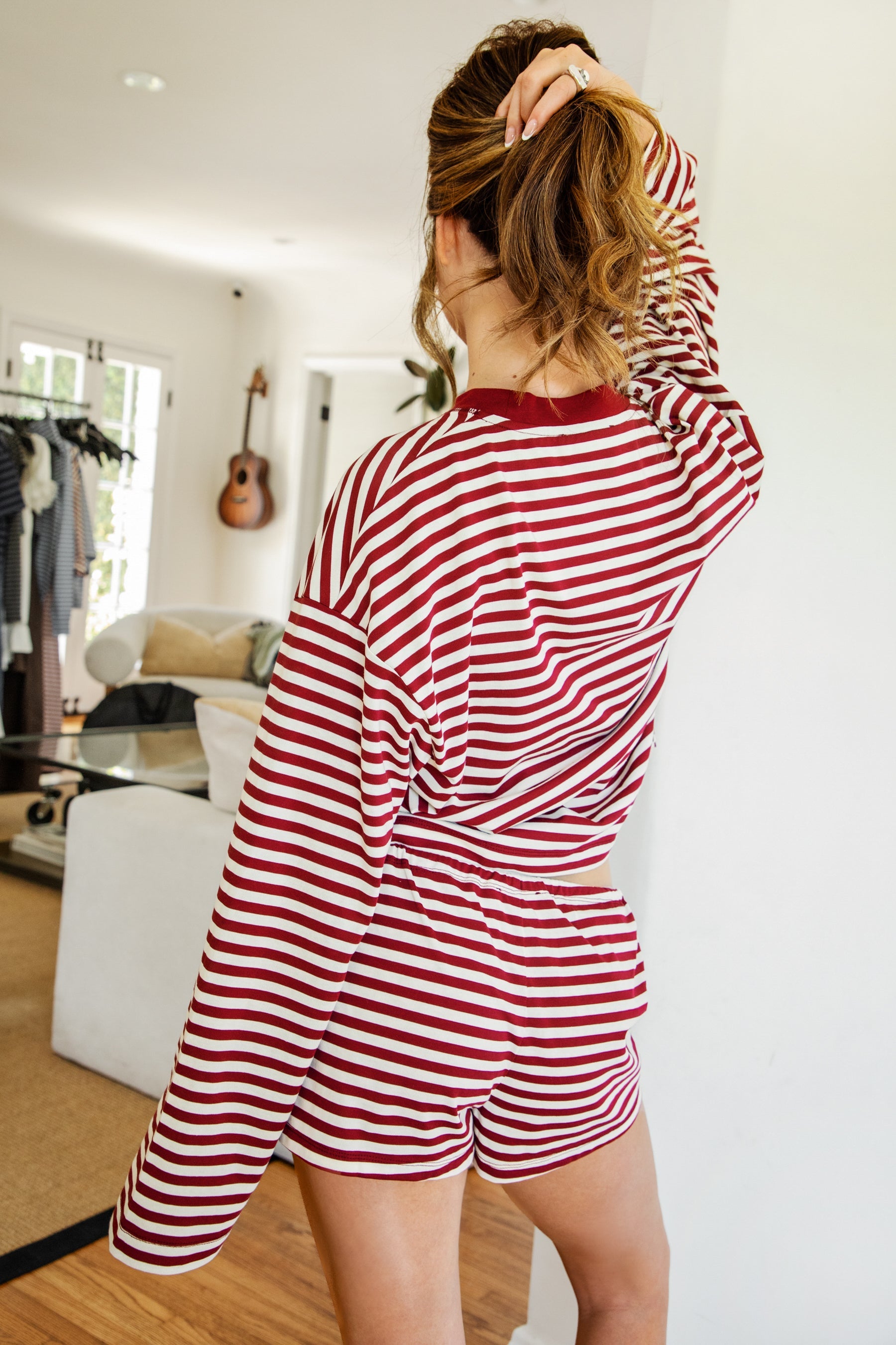 Woman wearing MARLOWE stripe mid waist drawstring stretch shorts featuring an allover stripe pattern, adjustable drawstring waistband, micro shorts length, relaxed easy fit silhouette, and soft stretch jersey fabric for cozy casual lounge styling.