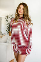 Woman wearing MARLOWE stripe mid waist drawstring stretch shorts featuring an allover stripe pattern, adjustable drawstring waistband, micro shorts length, relaxed easy fit silhouette, and soft stretch jersey fabric for cozy casual lounge styling.