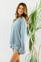 Woman wearing MARLOWE stripe mid waist drawstring stretch shorts featuring an allover stripe pattern, adjustable drawstring waistband, micro shorts length, relaxed easy fit silhouette, and soft stretch jersey fabric for cozy casual lounge styling.
