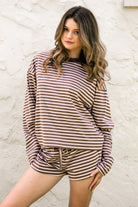 Woman wearing MARLOWE stripe mid waist drawstring stretch shorts featuring an allover stripe pattern, adjustable drawstring waistband, micro shorts length, relaxed easy fit silhouette, and soft stretch jersey fabric for cozy casual lounge styling.