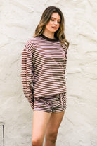 Woman wearing MARLOWE stripe mid waist drawstring stretch shorts featuring an allover stripe pattern, adjustable drawstring waistband, micro shorts length, relaxed easy fit silhouette, and soft stretch jersey fabric for cozy casual lounge styling.