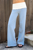 Woman wearing BRISA French terry stripe foldover waist wide leg pants featuring soft stretch French terry fabric, contrast foldover waistband, flattering low rise look, relaxed wide leg silhouette, classic stripe pattern, and pull on design for easy lounge and travel styling.