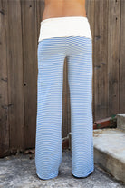 Woman wearing BRISA French terry stripe foldover waist wide leg pants featuring soft stretch French terry fabric, contrast foldover waistband, flattering low rise look, relaxed wide leg silhouette, classic stripe pattern, and pull on design for easy lounge and travel styling.
