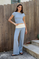 Woman wearing BRISA French terry stripe foldover waist wide leg pants featuring soft stretch French terry fabric, contrast foldover waistband, flattering low rise look, relaxed wide leg silhouette, classic stripe pattern, and pull on design for easy lounge and travel styling.