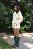 Woman wearing PIPPA polka dot plush fleece shorts featuring soft cotton blend fleece fabric, playful polka dot print, comfortable elastic waistband, easy pull on design, relaxed fit through the hips and legs, functional side pockets, short length, and clean finished hems designed to pair with the matching PIPPA sweatshirt.