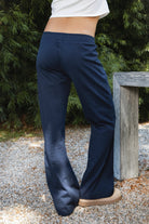 Woman wearing NAVYN waist band cotton wide leg pants featuring soft 100 percent cotton fabric, low rise waistline, relaxed fit, elastic waistband with adjustable drawstring tie, relaxed silhouette through the hips and thighs, wide leg design, full length cut, and straight hem for easy everyday styling.