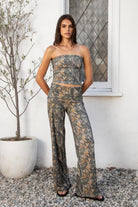 Woman wearing BAYOU dark woodland camo stretch foldover wide leg leggings featuring soft brushed stretch jersey fabric, allover woodland camo print, adjustable foldover waistband, relaxed wide leg silhouette, and four way stretch fabric designed for everyday comfort and easy movement.