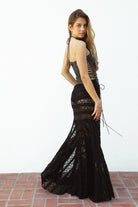 Woman wearing MARISS stretch lace side slit long skirt featuring sheer stretch lace fabric, flowy silhouette with airy movement, high side slit, picot trim waistband, and built-in micro shorts lining for coverage and comfort.