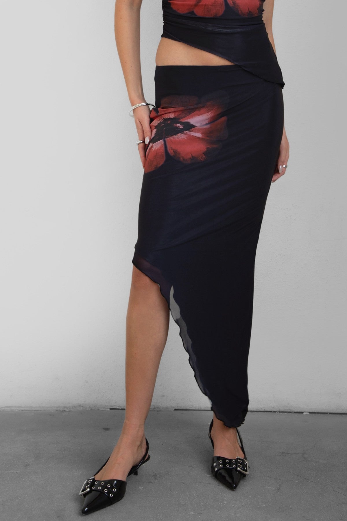 TIC TOC SC30926 MUAH S Mesh Print Asymmetrical Skirt featuring abstract floral mesh design with mid-rise waist and angled hem.