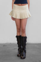 EMMA Low Rise Mini Skort 
Low Rise Sexy Pleated Mini Skirt 
Built-In Under Shorts 
Bold Pleats at the Hem 
Low-Rise Waist Band 
Stretch Denim Like Fabric 