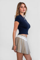 Woman wearing TIC TOC SH31098-JENS heathered twill mini skirt featuring a stone contrast waistband, crisp pleats throughout, side zipper closure, and a tailored skater silhouette for a polished preppy look.