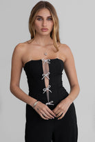 TIC TOC TA30224 KARMEN Strapless Corset Top with sheer center cutout and rhinestone bow embellishments.