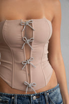 TIC TOC TA30224 KARMEN Strapless Corset Top with sheer center cutout and rhinestone bow embellishments.