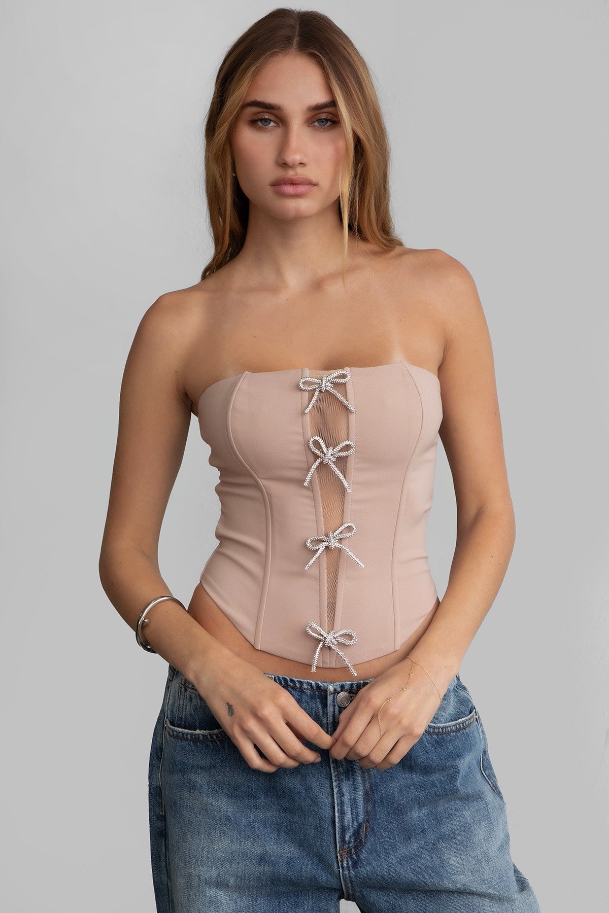 TIC TOC TA30224 KARMEN Strapless Corset Top with sheer center cutout and rhinestone bow embellishments.