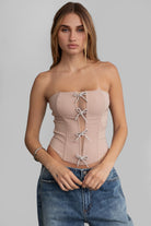 TIC TOC TA30224 KARMEN Strapless Corset Top with sheer center cutout and rhinestone bow embellishments.