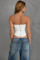 TIC TOC TA30224 KARMEN Strapless Corset Top with sheer center cutout and rhinestone bow embellishments.
