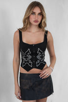 TIC TOC JESSIE Embroidered Suede Corset in Black with square neckline, faux button front, and lace-up back.