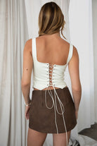 TIC TOC JESSIE Embroidered Suede Corset in Cream with square neckline, faux button front, and lace-up back.