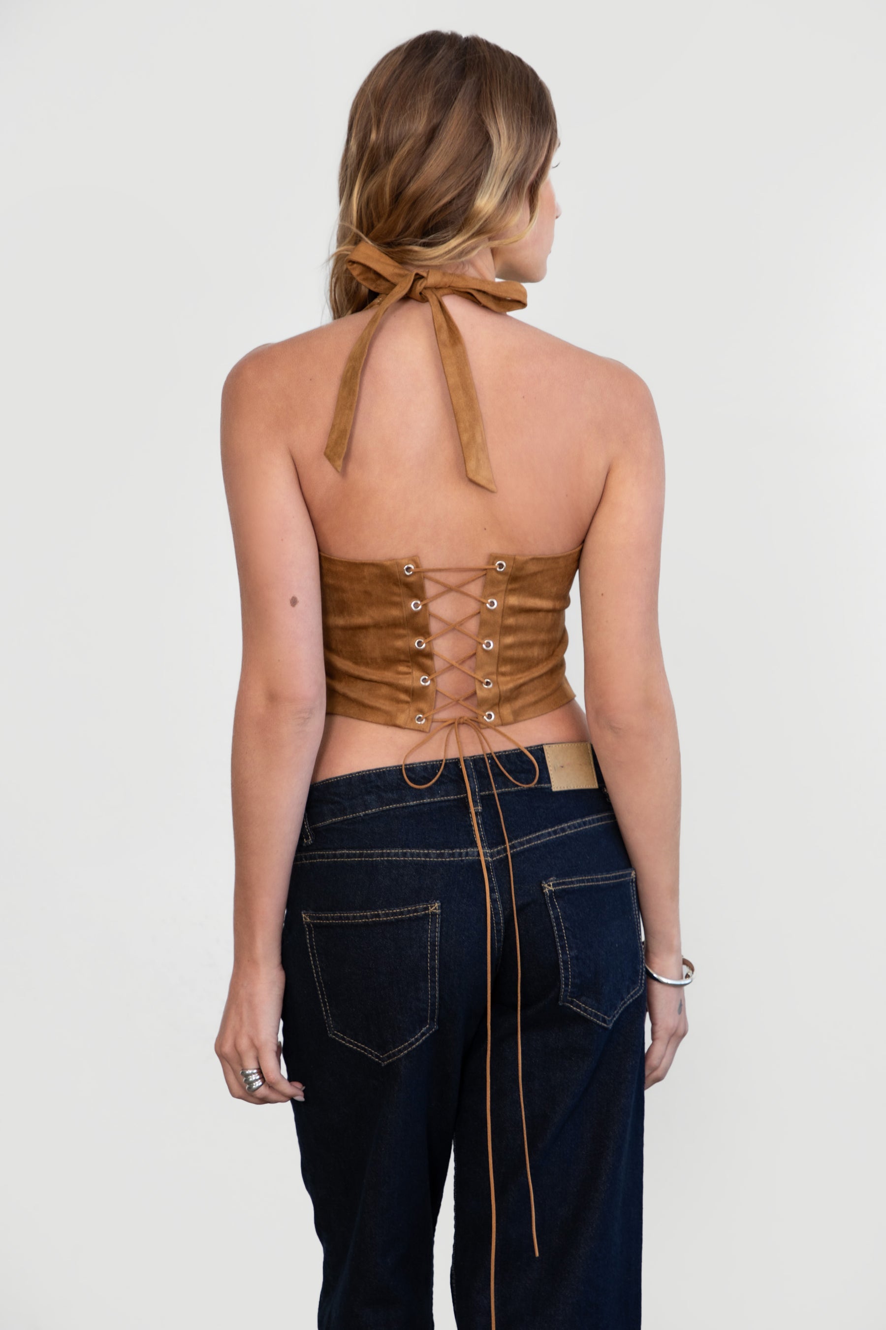 Back view of Tan MARGEE halter paired with denim jeans