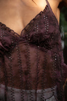 Woman wearing TIC TOC TA31758 ISOLA scalloped sequin chiffon open back halter top featuring a ruffle-trim V-neckline, delicate sequin embroidered chiffon, adjustable self-tie halter neck, open back tie closure, and a scalloped handkerchief hem, styled for a romantic vacation and elevated western evening look.
