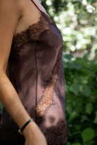 Woman wearing TIC TOC TA31968 SELINNE satin lace contrast V-neck cami top featuring smooth satin fabric, a flattering V neckline with scalloped lace trim, thin adjustable shoulder straps, and an asymmetrical lace-trim hem for a soft feminine date-night look.