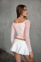 TIC TOC TC31111 ADORA Mesh Rhinestone Embellished Long Sleeve Top in pink. Features an off-the-shoulder neckline, lace trim with self-tie detail, and sparkling rhinestones.