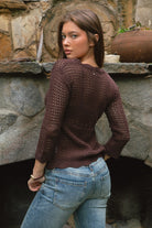 Woman wearing TC31632-ASHLYN crochet cardigan featuring a scalloped V-neckline, tie-front closure, peplum hem, and three-quarter sleeves styled as a lightweight boho western Y2K layering piece.