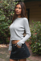 Woman wearing TIC TOC TC32069 KRISTY cable knit basic long sleeve cardigan top featuring a soft lightweight cotton cable knit texture, round neckline, full front button closure, slim fit silhouette, and semi-cropped length for a polished preppy everyday look.