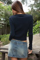 Woman wearing TIC TOC TC32069 KRISTY cable knit basic long sleeve cardigan top featuring a soft lightweight cotton cable knit texture, round neckline, full front button closure, slim fit silhouette, and semi-cropped length for a polished preppy everyday look.