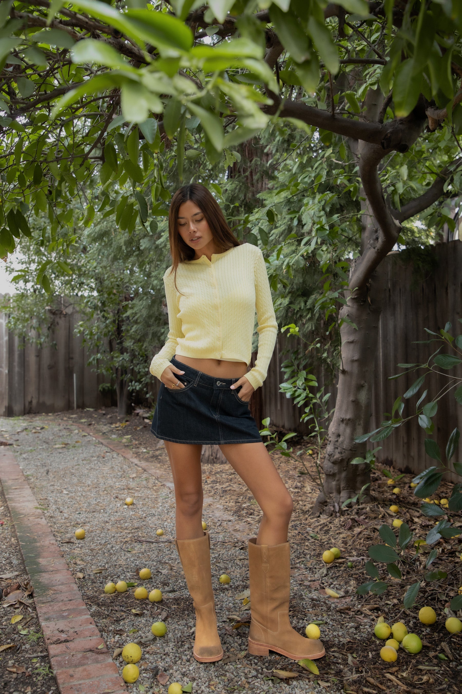 Woman wearing TIC TOC TC32069 KRISTY cable knit basic long sleeve cardigan top featuring a soft lightweight cotton cable knit texture, round neckline, full front button closure, slim fit silhouette, and semi-cropped length for a polished preppy everyday look.